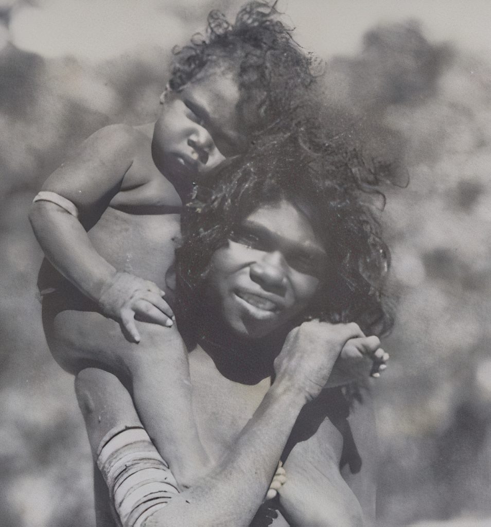 A mother and child wearing simple armbands. c1935. Arnhem Land, Northern Territory.